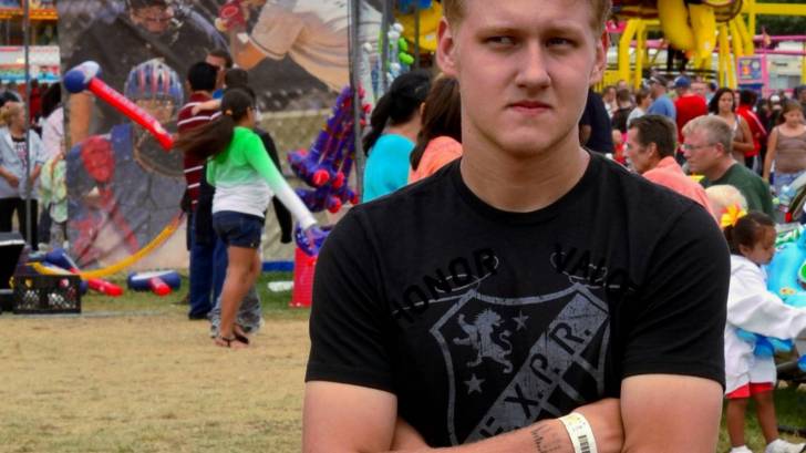 young man standing with arms crossed