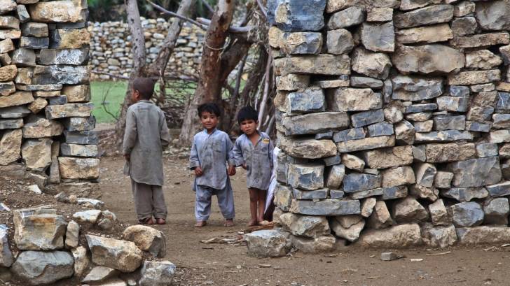 poor children in dirt home, unsanitary conditions