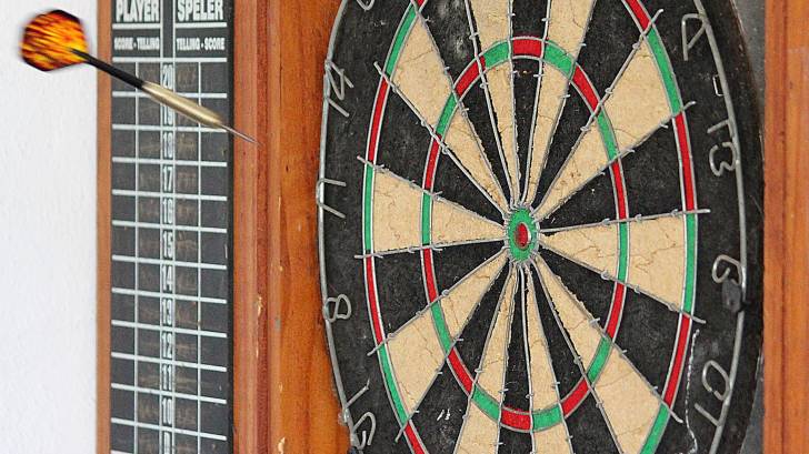 dart board, dart in the air towards the target