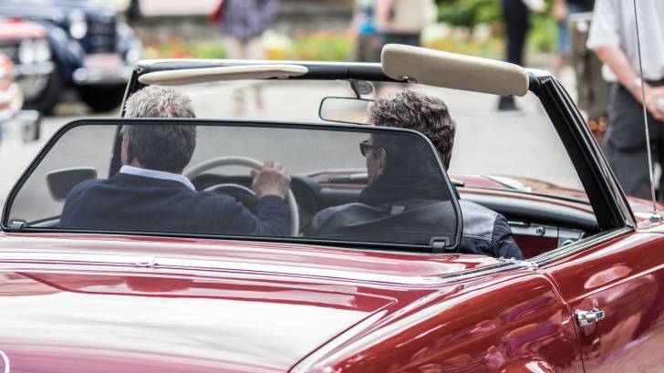 convertible car driving up 