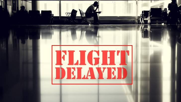 airport with sign saying flight delayed