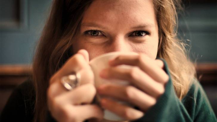 woman drinking a cup of tea, happy
