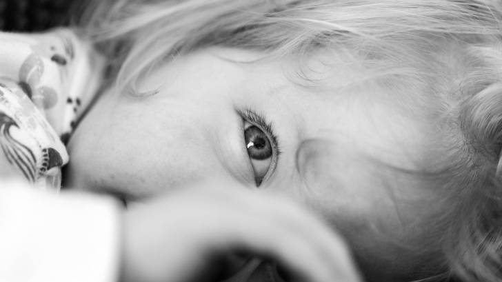 young girl looking through her hand