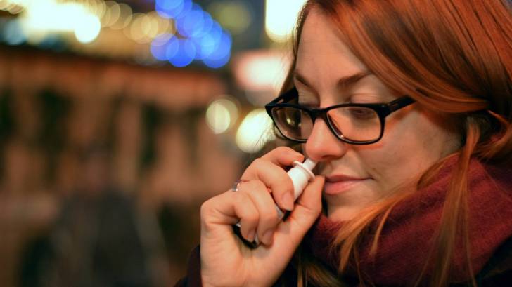 woman using a nasal spray