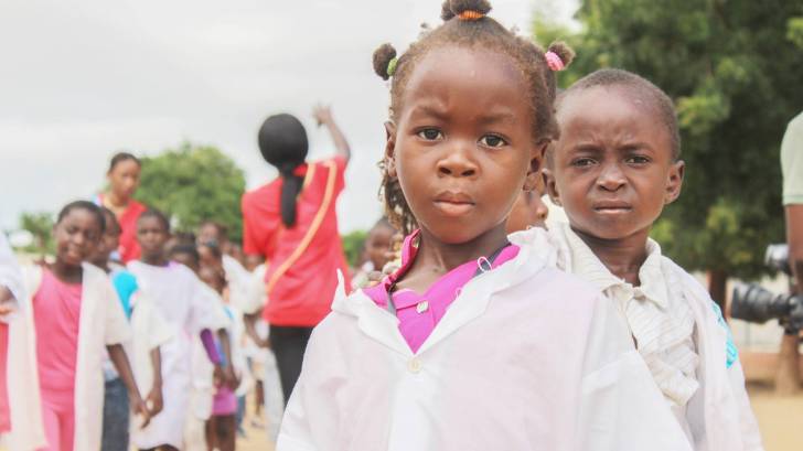 young children in lab coats waiting to be tested