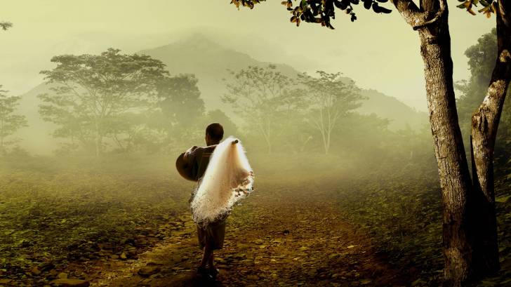 thai fisherman walking in the woods with fog