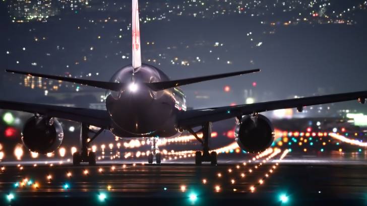 plane landing in the night time lights