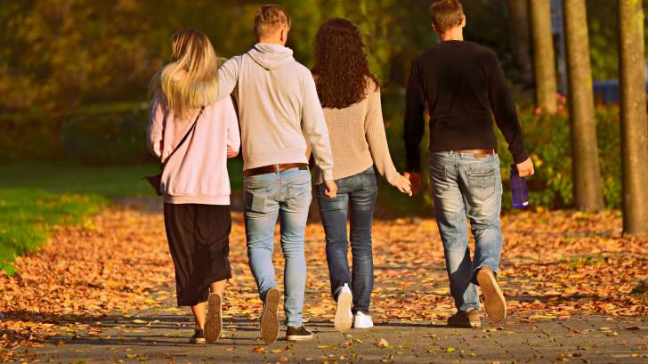 4 people walking in a park