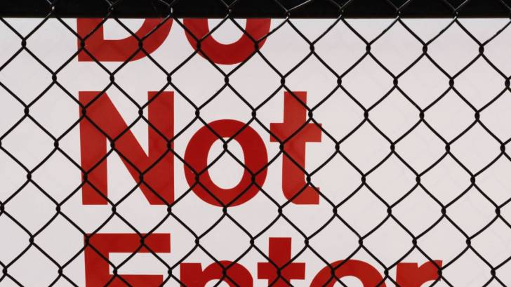 do not enter sign behind a fence