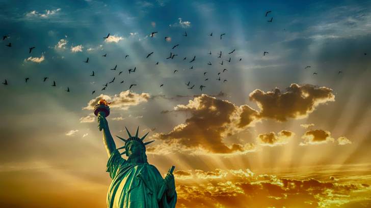 staute of liberty with clouds in the background