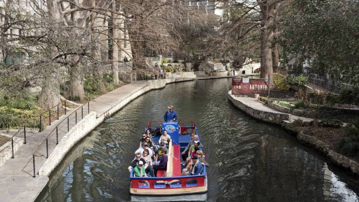 river walk in san antonio with a tourist barge