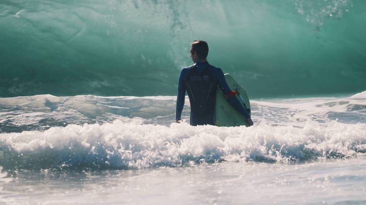 surfer with big waves heading his way