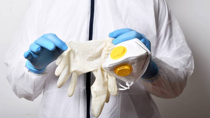 medical personel holing face mask and gloves