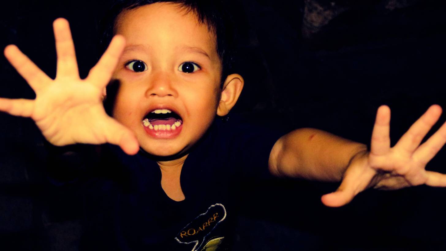 young boy screaming happy