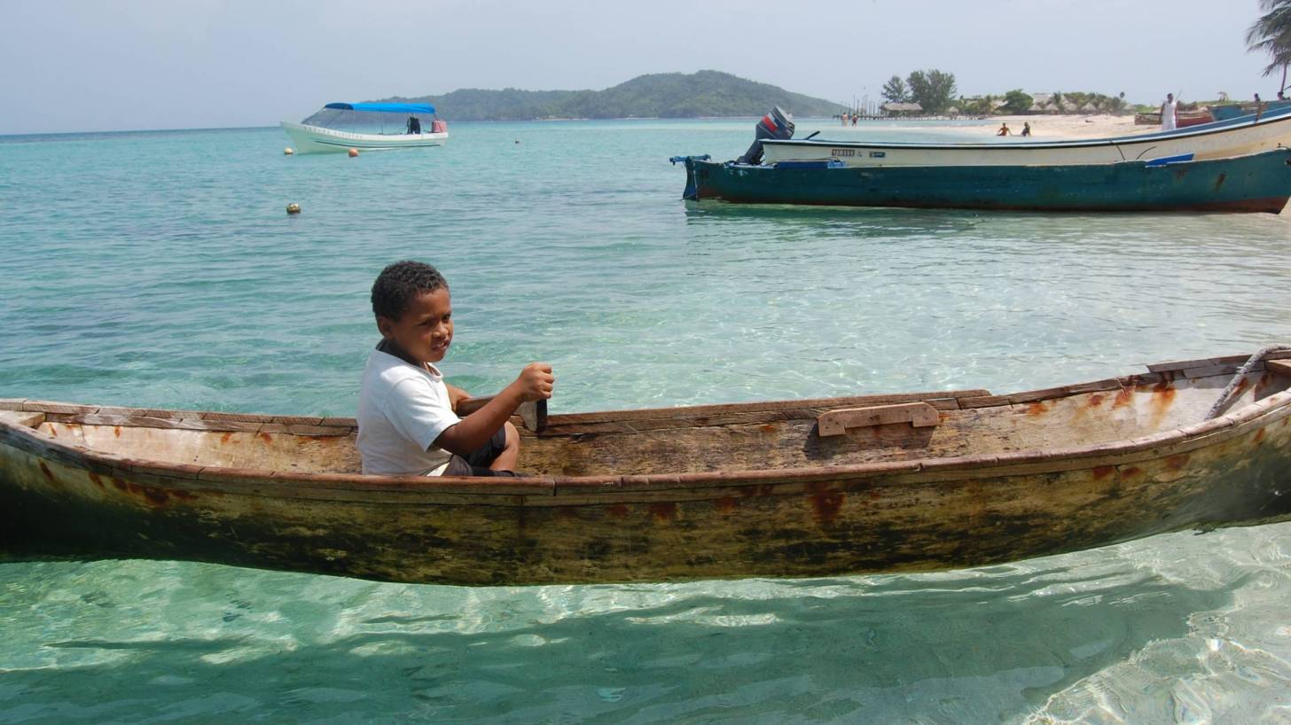 hondurus boy in a canoe
