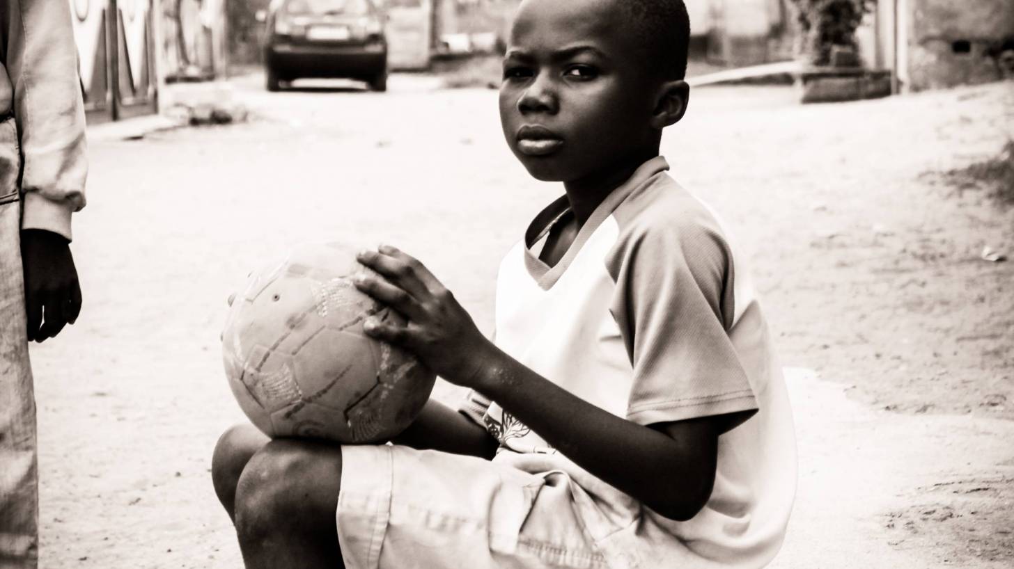 young african child with a basket ball