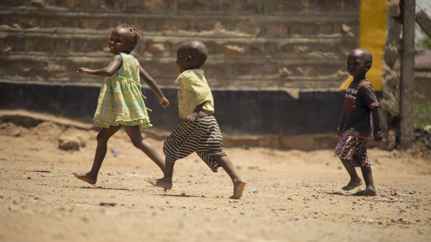 young african children playing in a yard