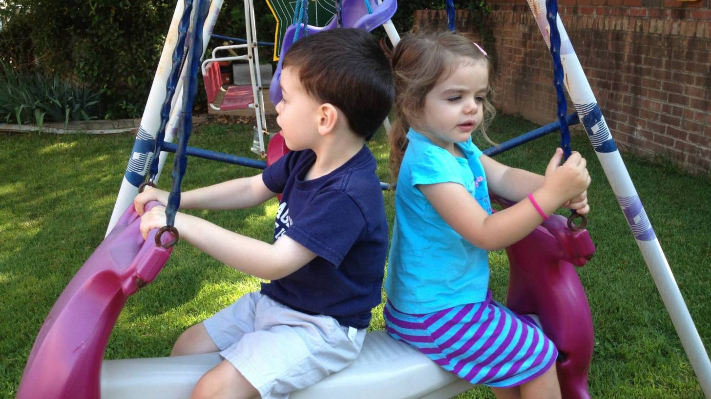 children swinging on playground