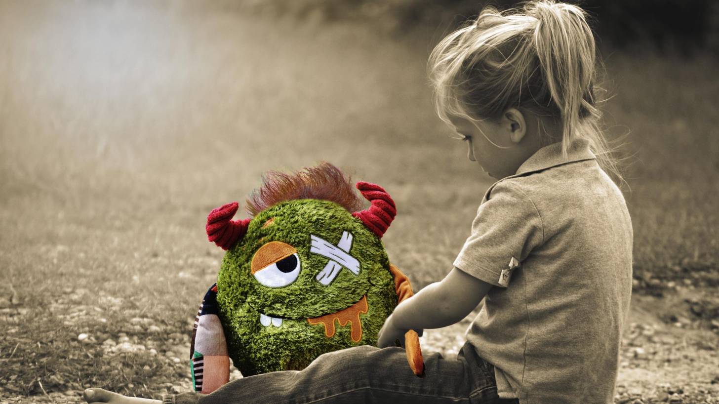 young girl fixing her stuffed animal