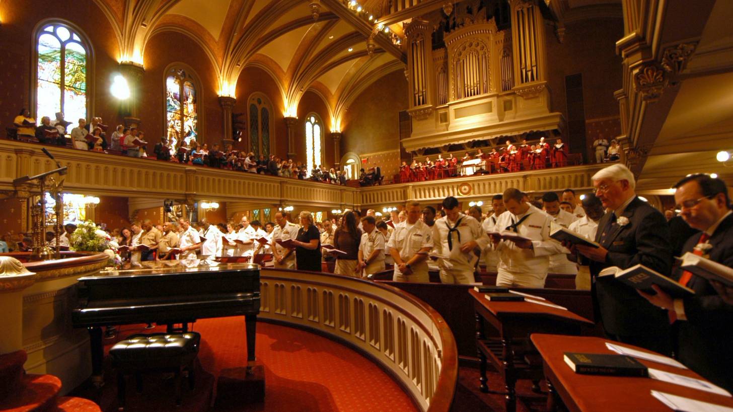inside a church of worship with people praying