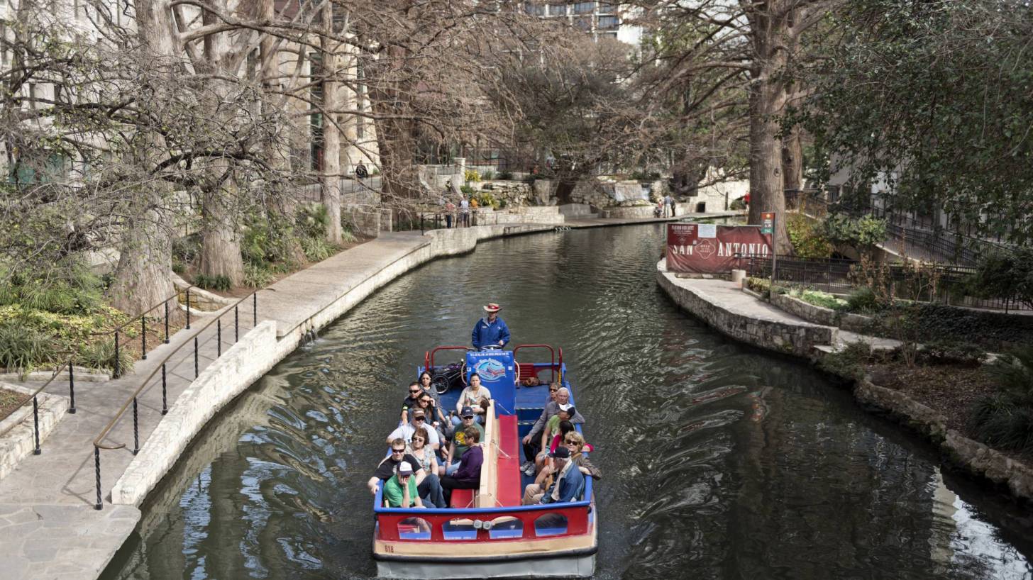 river walk in san antonio with a tourist barge