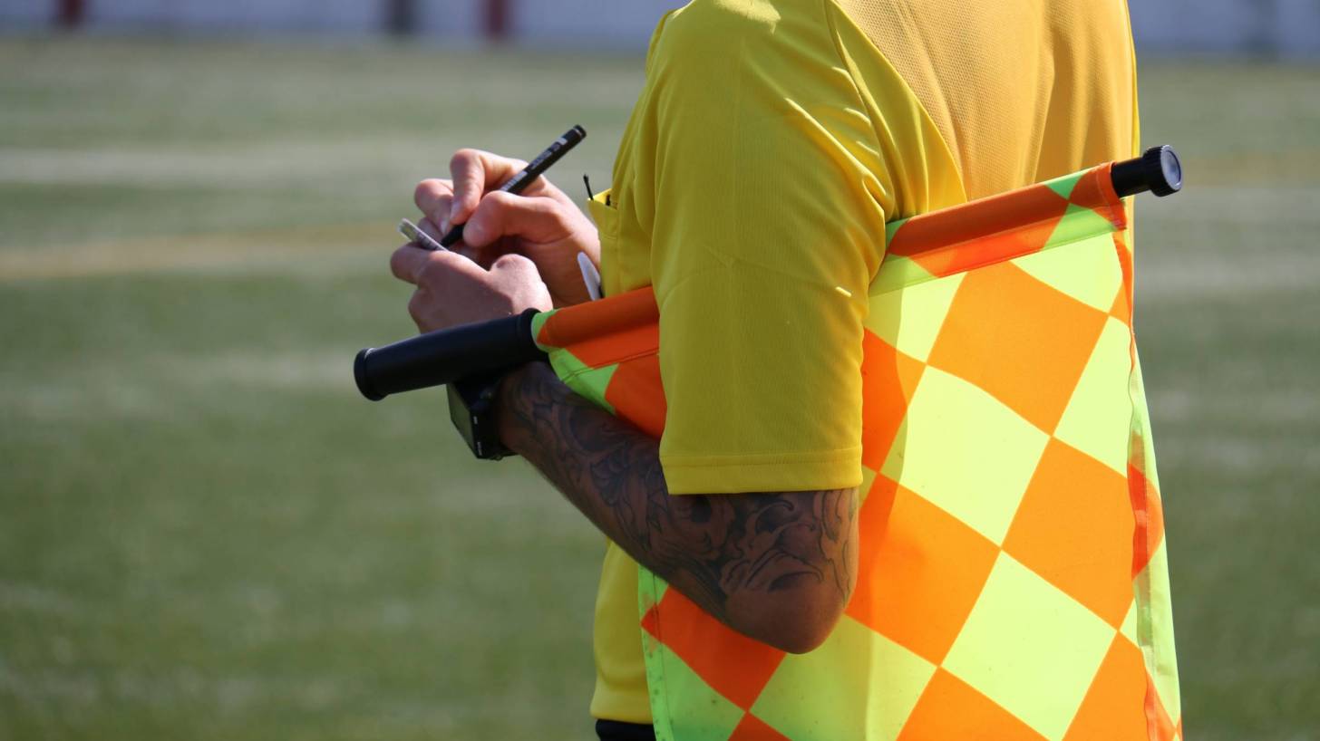 soccer ref with yellow card