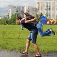 man carrying female on his back helping