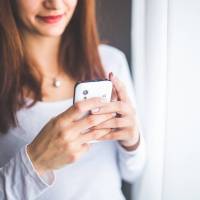 woman looking at her smart phone app