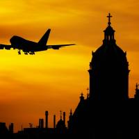 plane taking off into the sunset