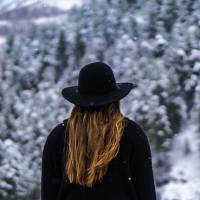 young women sitting in a snowy forest