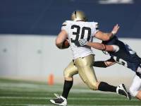 football player stiff arming another player